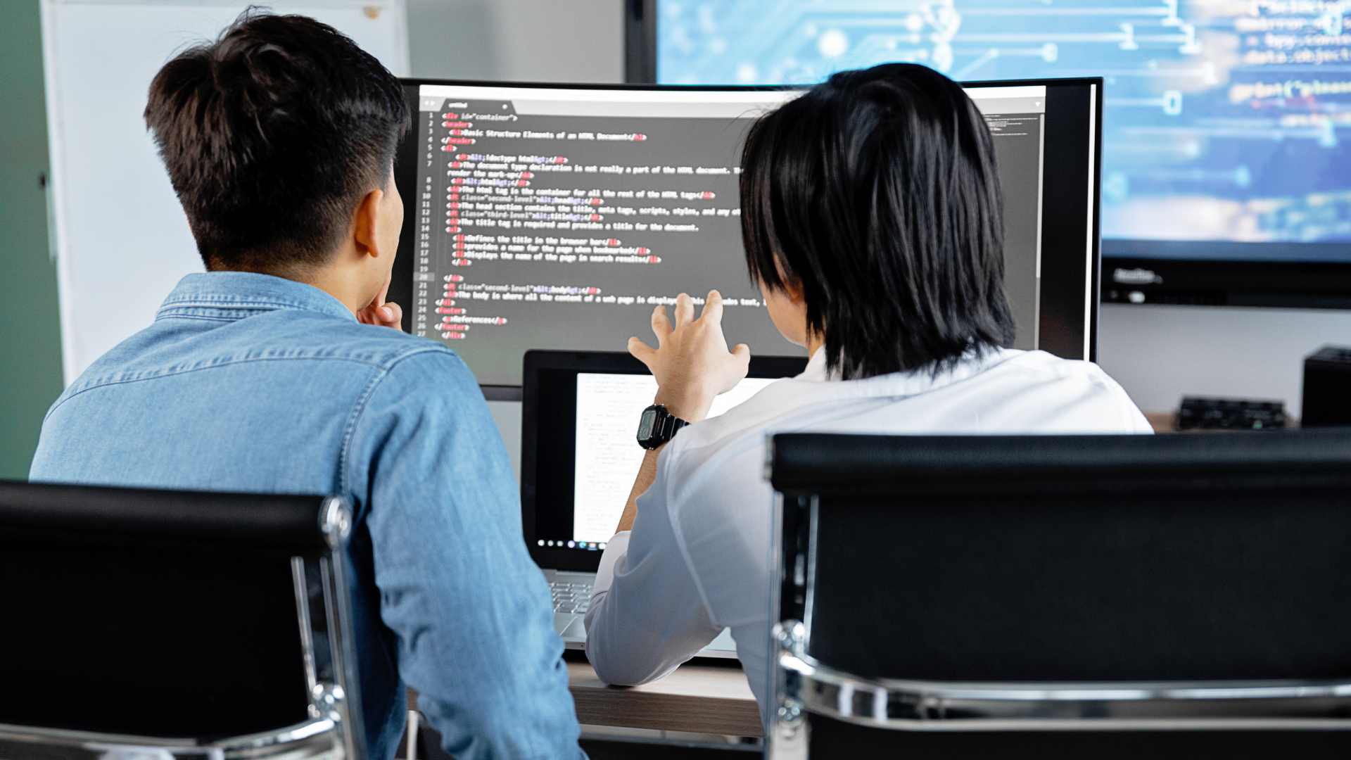 Two business professionals working on a computer