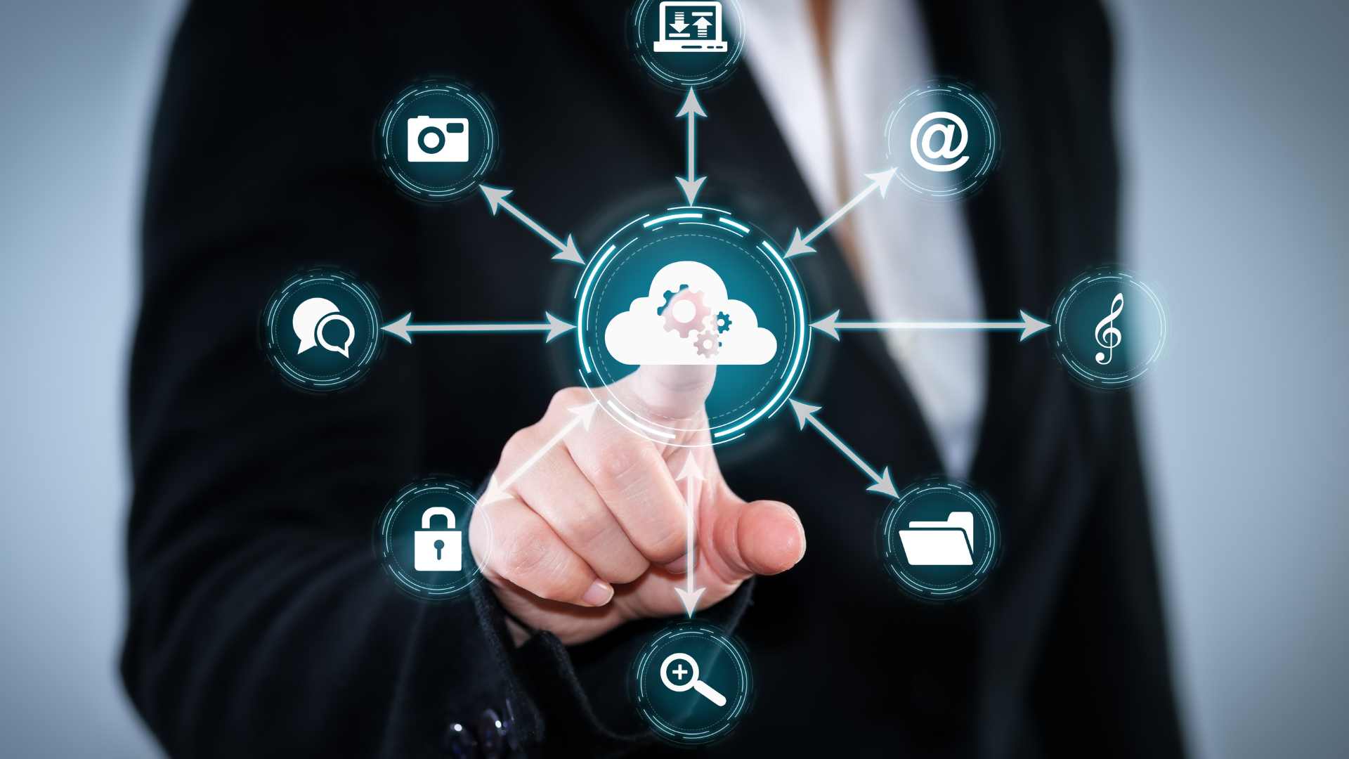 A person pointing at a digital cloud icon on a transparent touchscreen, surrounded by various technology-related icons