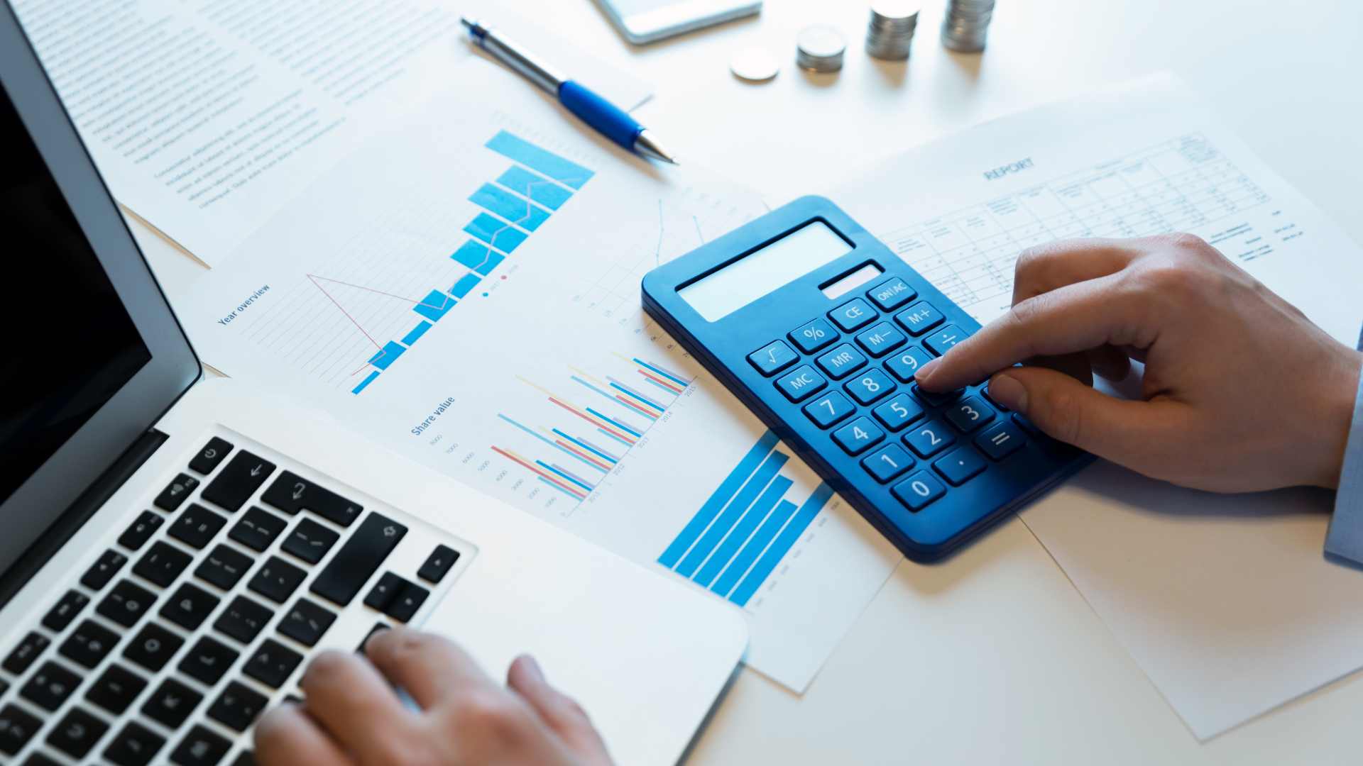 Business professional working on a laptop and calculator 
