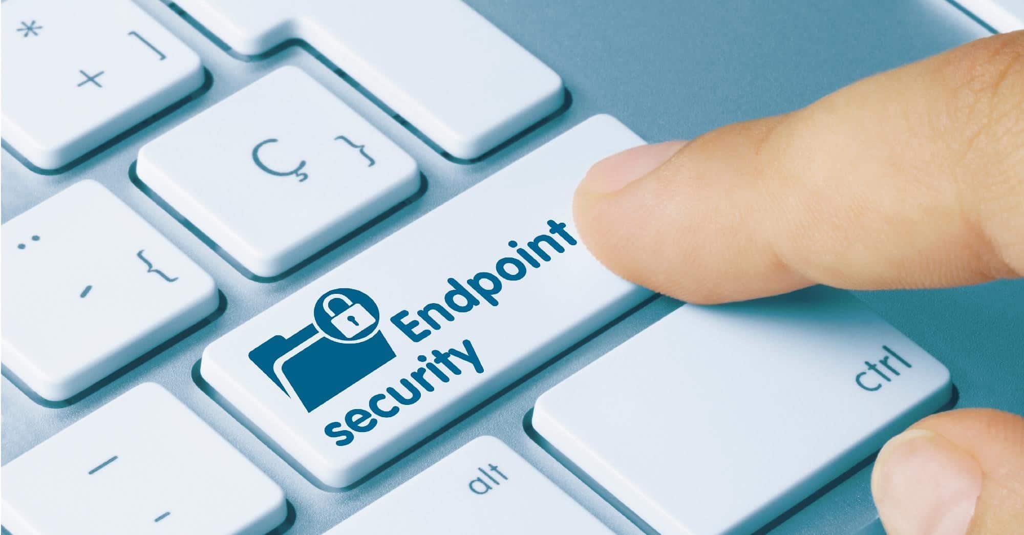 A finger pressing a endpoint security button on a keyboard