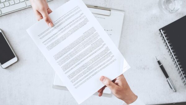 A document being handed to a person