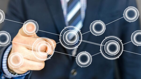 an abstract image of a man pointing at one of many connected dots that overlay the image