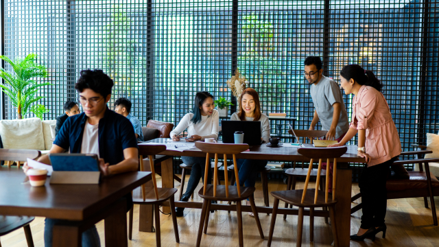 People working on their computers and tablets in a cafe