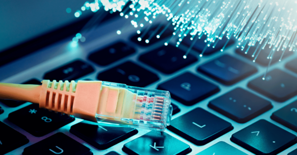 Strands of fiber and an ethernet cable on a keyboard