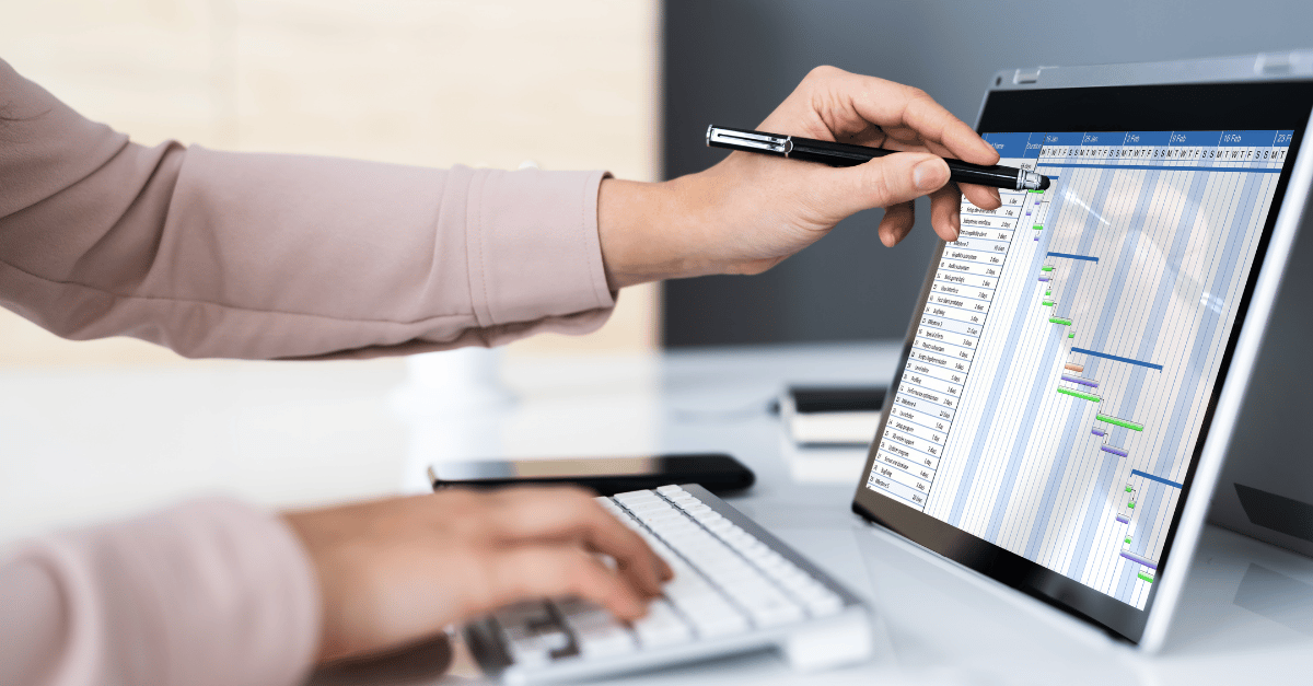 A project manager using a tablet to work on spreadsheets 